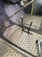 Interior view of a 1955 Chevy 3100 showing the transfer case shifter and floor mat.