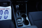 Interior view of a 2019 Hyundai Tucson SE showing gear shift and cup holders.