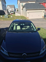 Front view of a 2022 Volkswagen Jetta S FWD parked in a residential area, showcasing its sleek design.