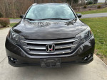 Front view of a 2014 Honda CR-V EX-L in excellent condition, showcasing its sleek design and chrome grille.