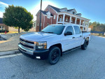 2010 Chevrolet Silverado 1500 LT 4WD in white, parked on street near residential area.