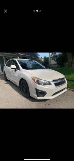 White 4WD Subaru Impreza hatchback for sale, equipped with new tires and a clean interior.