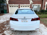 Rear view of a 2017 Acura TLX in great condition with minor scratches, parked in a driveway.