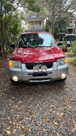 2007 Ford Escape XLT SUV in red and silver, front view with fog lights and clean design.