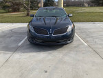 2014 Lincoln MKS parked with front view, showing no rust or mechanical issues, in excellent driving condition.