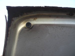 Close-up of the interior roof panel of a 2008 BMW 5 Series with wear and rust.