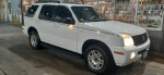 2005 Mercury Mountaineer SUV in white with beige interior, ideal for deliveries and all-weather handling.