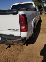 Rear view of a 2003 Chevrolet crew cab 1500HD truck with a salvage title and enhanced engine features.