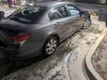 2010 Honda Accord EX-L in gray with chrome wheels parked at a gas station, showing back view and clean exterior.