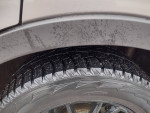 Close-up of the tire of a 2010 Mazda CX-9 Grand Touring highlighting its tread and wheel details.