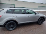 2010 Mazda CX-9 Grand Touring FWD in silver with new parts and black wheels, showcasing its side view.