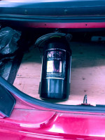 Nitrous oxide bottle in the trunk of a 1995 Mustang GT, showcasing performance enhancement features.