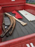 Interior view of a 1951 Willy's Jeep Pickup Truck showing parts and accessories in the cargo bed.