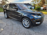 2017 Land Rover Range Rover HSE 4WD parked on the street, showcasing its sleek design and alloy wheels.
