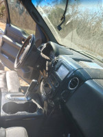 Interior view of a 2006 Ford Harley Davidson truck, showing the dashboard, steering wheel, and gear shift.