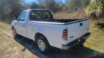 2001 Ford F150 regular cab with 81,500 miles, showing a clean exterior and truck bed on a sunny day.