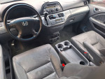 Interior view of a well-maintained Honda Odyssey with leather seats and modern controls.