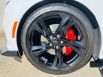 2023 Chevrolet Camaro 2SS RWD wheel close-up showcasing black alloy rims and red brake calipers