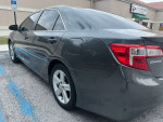 2013 Toyota Camry SE parked, showcasing sleek design and clean lines, perfect for budget-conscious buyers.