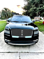 Front view of a black 2018 Lincoln Navigator Black Label parked outdoors, showcasing its pristine condition.