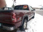 Maroon Chevrolet Silverado 1500 4x4 with Z71 off-road package, clean condition, parked in snowy surroundings.