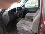Interior view of a clean 4x4 Chevrolet Silverado 1500, showing grey upholstery and dashboard features.