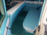 Interior view of a 1955 Chevrolet Station Wagon showcasing vintage blue and white seating.