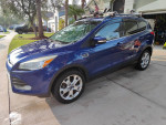 2013 Ford Escape S FWD in blue color parked in driveway, featuring roof rack and shiny alloy wheels.