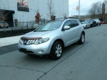 2012 Nissan Murano silver SUV parked on street, clean title, all-wheel drive, great running condition.