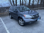 2010 Honda CR-V EX FWD parked in a lot, showcasing its sleek design and all-wheel drive capability.