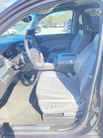 Interior view of a 2017 Chevrolet Tahoe LT 2WD with clean leather seats and modern dashboard features.
