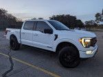 2023 Ford F150 FX4 Hybrid truck in white with black accents, showcasing advanced features and towing capacity.