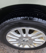 Close-up of a wheel and tire on a 2008 Toyota Sienna, showcasing the alloy rim and tread pattern