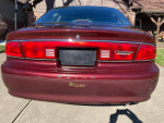 Back view of a 2002 Buick Century Special Edition with low mileage, showcasing its red tail lights and emblem.