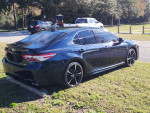 2020 Toyota Camry XSE FWD in Galactic Aqua parked in a scenic area, showcasing its sleek design and leather seats.