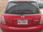 Rear view of a red 2005 MINI Cooper S with Texas license plate, showcasing its sporty design.