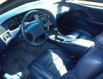 Interior view of a well-maintained 1994 Mercury Cougar with blue leather seats and dashboard.