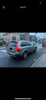 2007 Volvo XC90 AWD parked on the street, showcasing its rear design and clean condition.