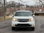 Front view of a 2014 Honda Pilot EX-L in white, parked on a residential street.