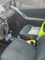 Interior view of a Toyota Yaris hatchback with clean seats and upgraded radio.