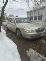 2009 Buick Lucerne CXL FWD parked on a street, featuring new tires and a few cosmetic imperfections.
