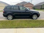2007 BMW X3 parked on the street, showcasing sleek design and luxurious features with low mileage.