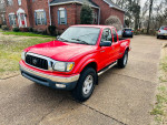 2003 Toyota Tacoma V6 pickup truck in red parked on driveway with clean title and 137,000 miles