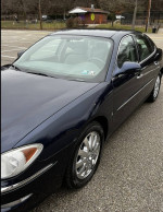 2008 Buick LaCrosse CX in Imperial Blue with chrome wheels, showcasing its stylish exterior and low mileage.