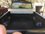Interior view of Tacoma pickup truck bed with diamond plate toolbox and rubber lining