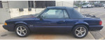 1993 Ford Mustang LX convertible in royal blue with a clean interior and new top, parked on a street.