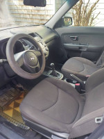 Interior view of a 2011 Kia Soul with manual transmission and modern dashboard features.