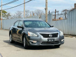 2015 Nissan Altima 2.5 S gray sedan parked on the street, showcasing its clean body and rear view camera features.
