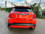 Rear view of a clean orange 2016 Fiat 500X Easy Edition AWD parked on a street