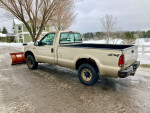 2000 Ford F250 Super Duty Plow Truck with Western Unimount plow parked in wintery setting